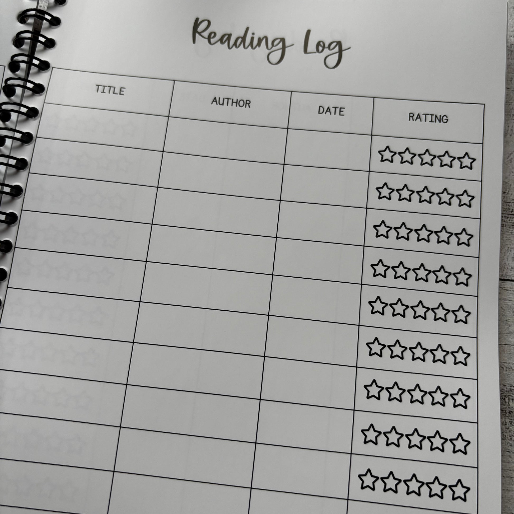 Reading log sheet with star rating system on a notebook page.
