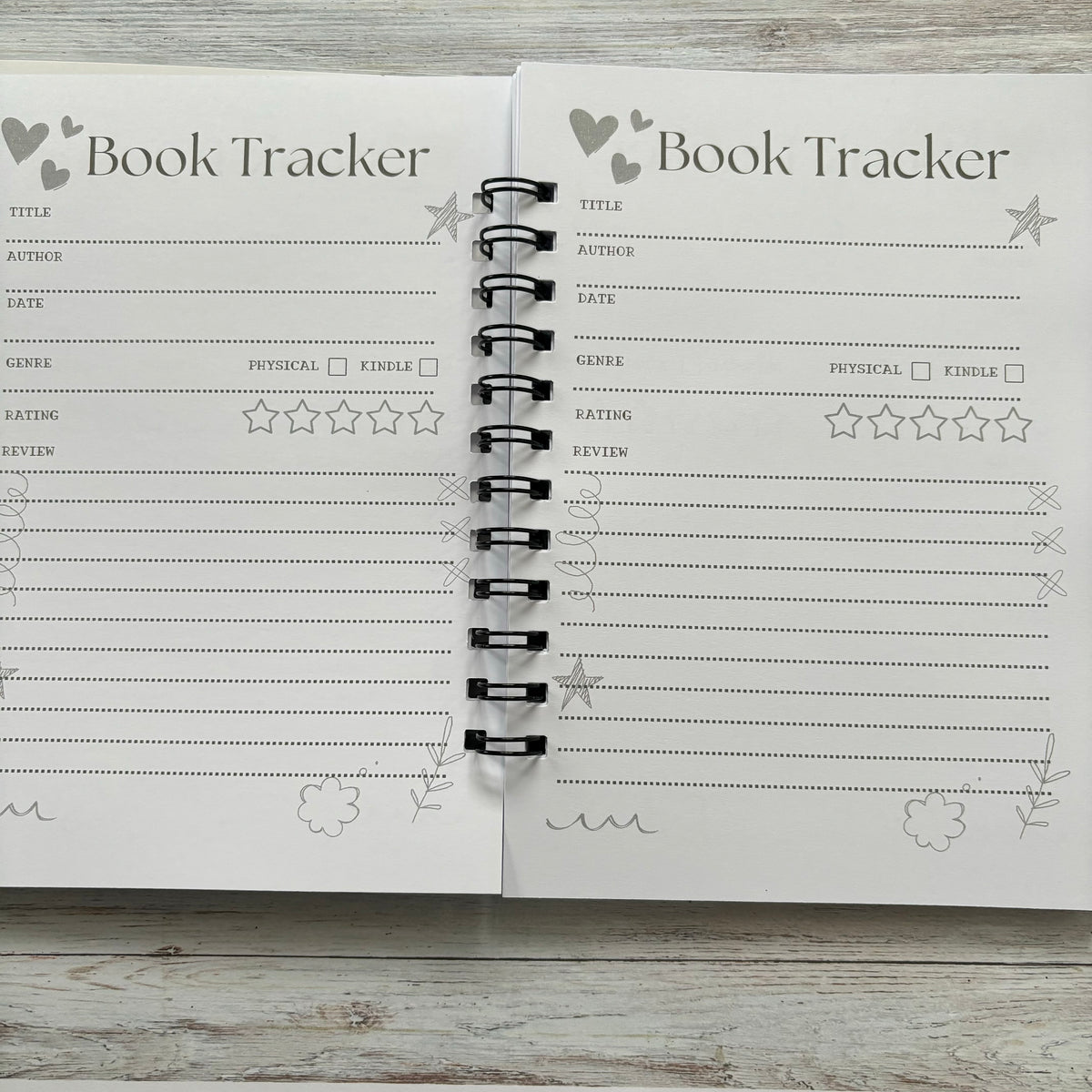 Open book journal with book tracker page fore full page book reviews