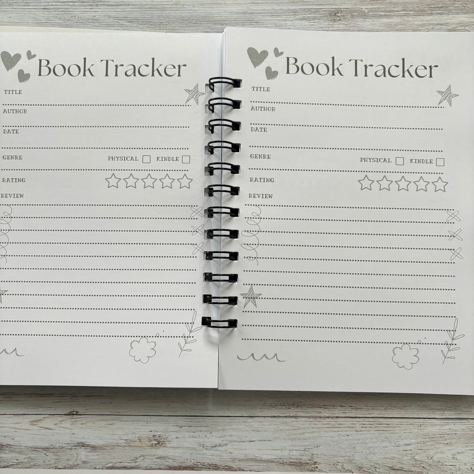 Open book journal with book tracker page fore full page book reviews