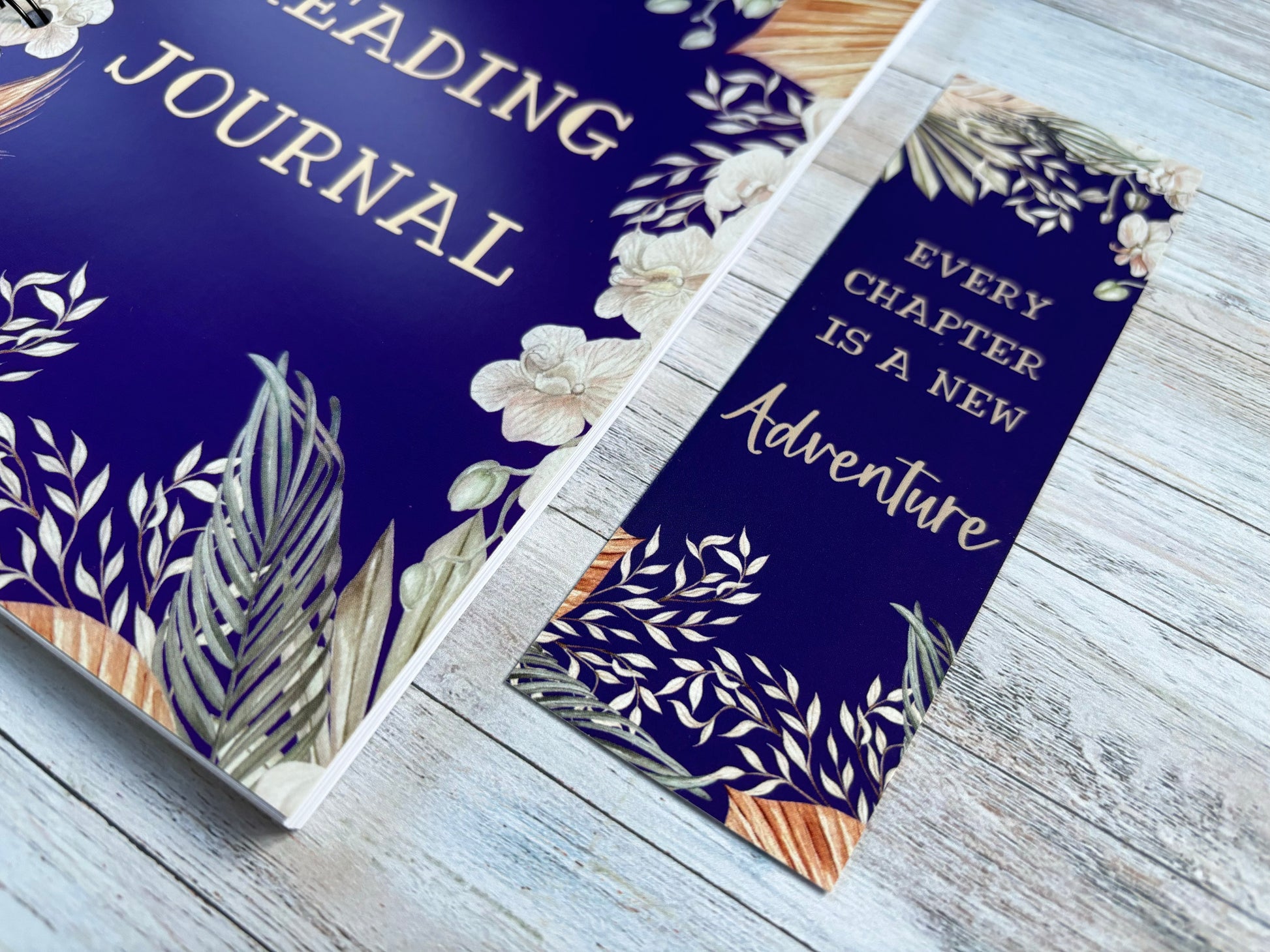 Close up view of blue reading journal and matching blue floral bookmark