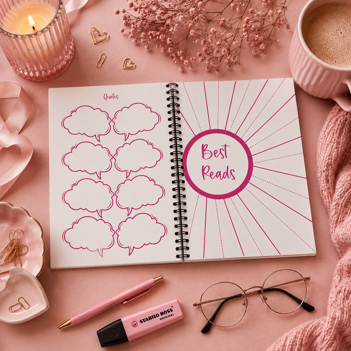 A spiral-bound reading journal or planner spread open on a pink surface, with decorative props including a candle, flowers, a mug of coffee, a pen, glasses, and a highlighter. The left page has pink cloud-shaped quote boxes, and the right page has a pink circular badge reading 'Best Reads' and 'Quotes'