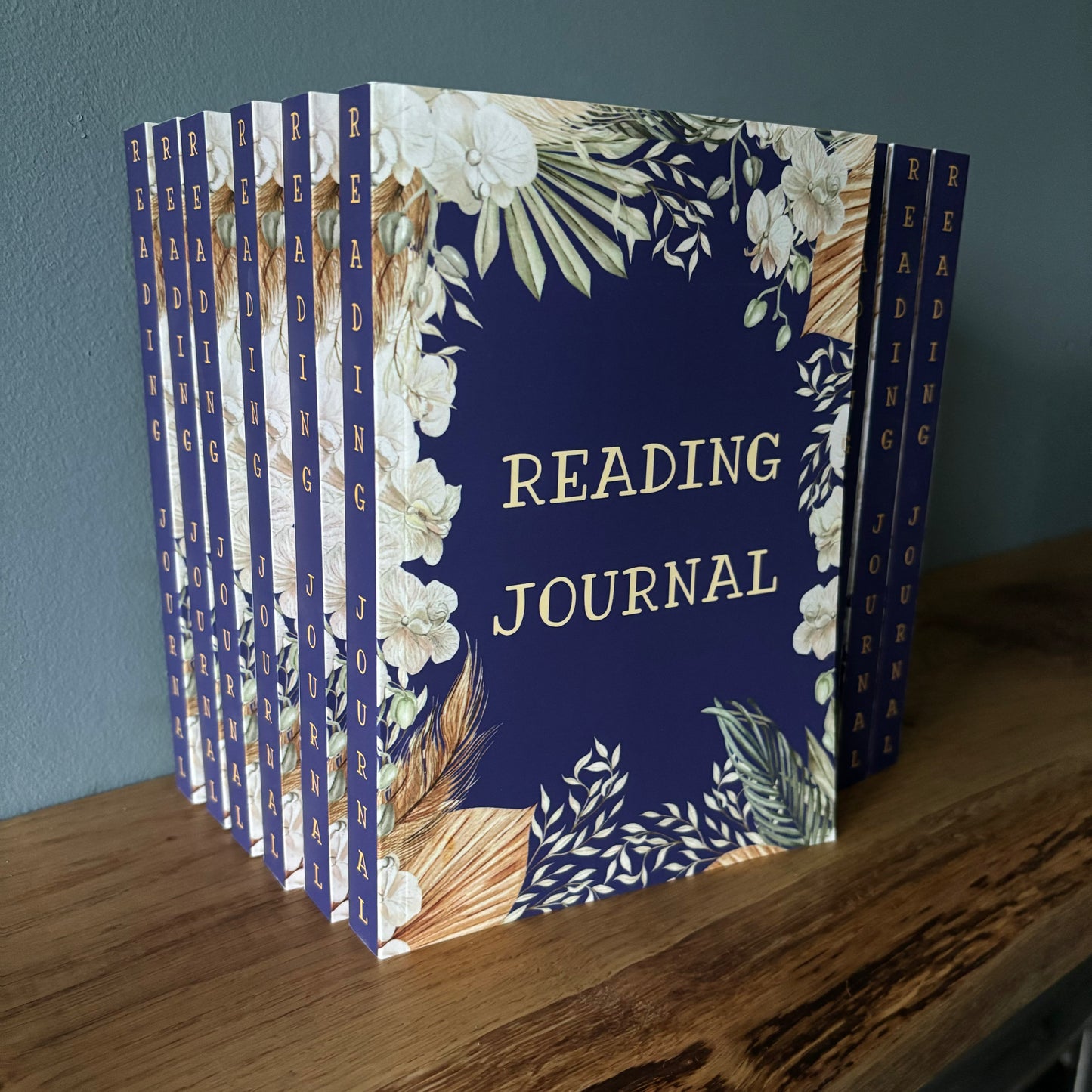 Reading journals in navy blue floral design with reading journal on the spine
